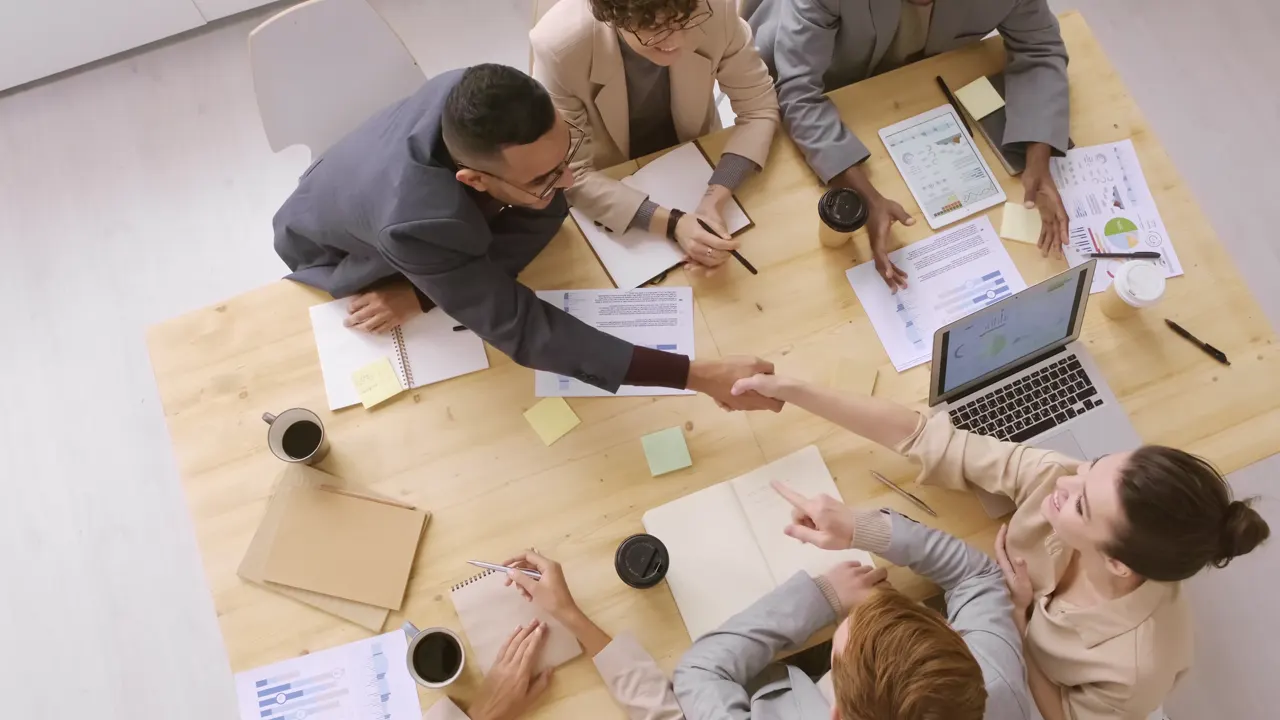 Colleagues sharing ideas around a meeting table